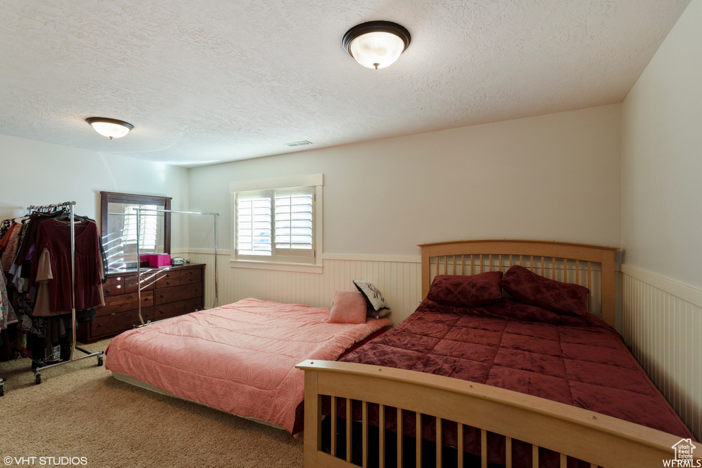 Bedroom with carpet floors and a textured ceiling