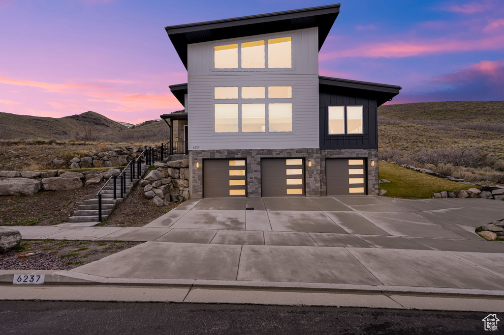 Contemporary house with a mountain view and a garage