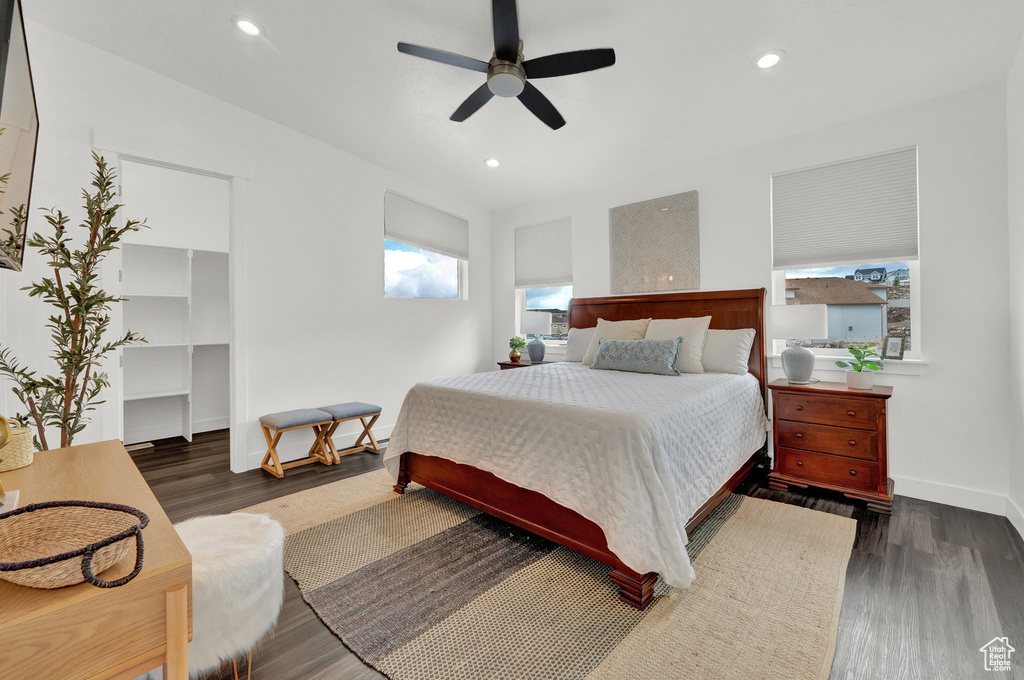 Bedroom with ceiling fan and dark wood-type flooring