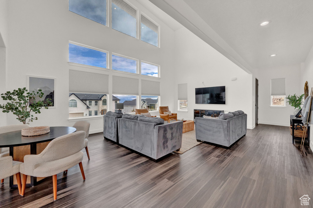 Living room with a high ceiling and dark hardwood / wood-style floors