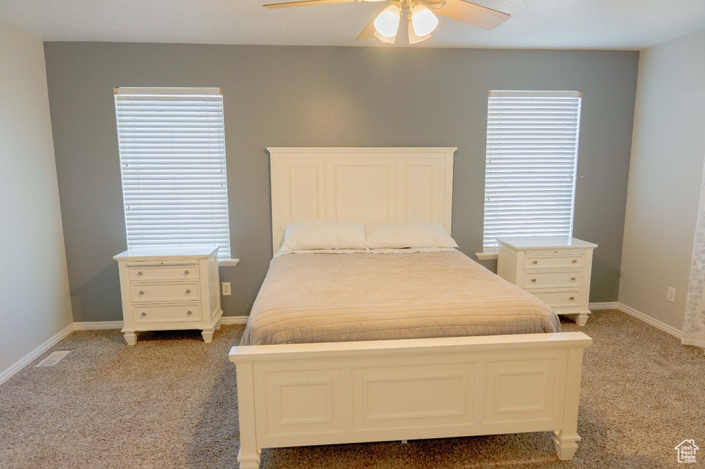 Bedroom featuring dark carpet and ceiling fan