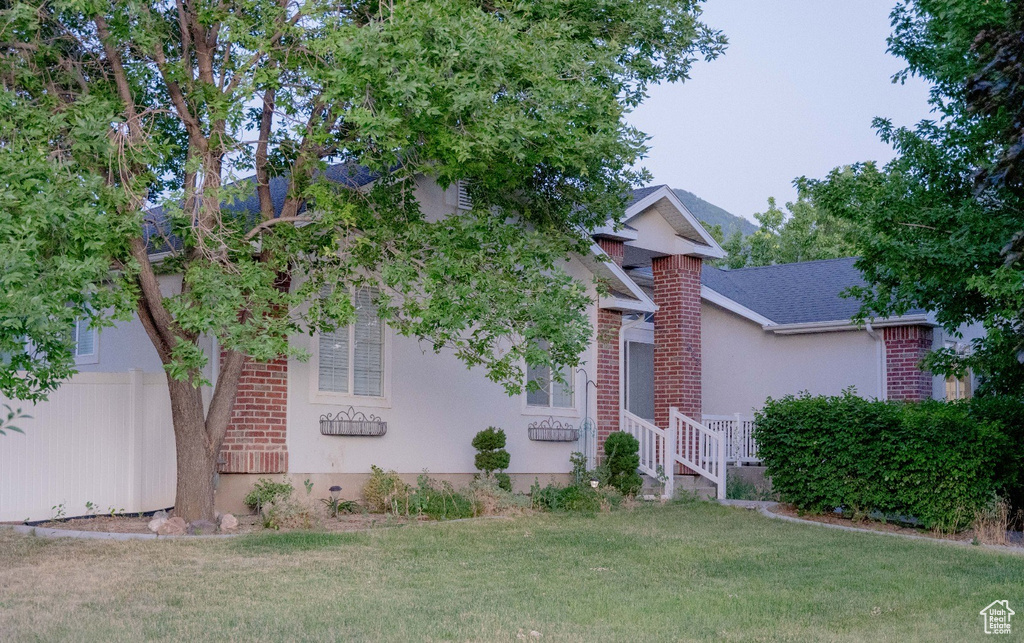 Obstructed view of property with a front yard