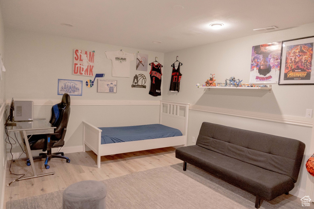 Bedroom with hardwood / wood-style floors