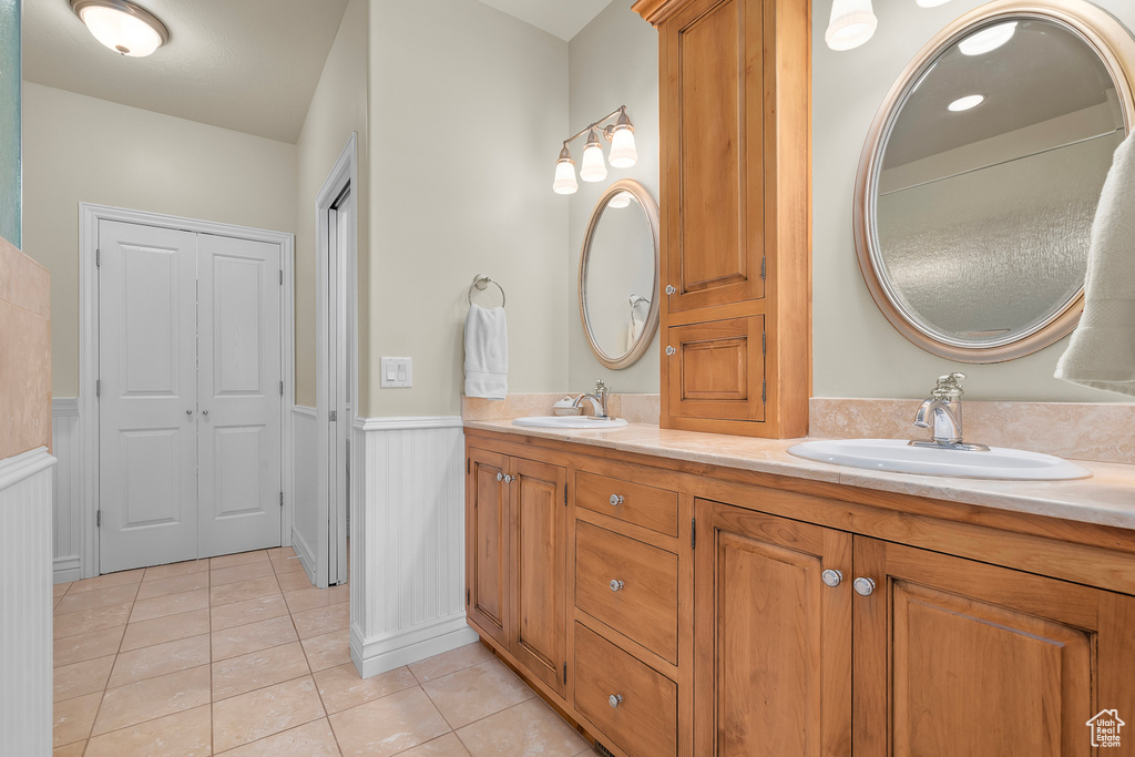 Bathroom featuring double vanity and tile patterned flooring