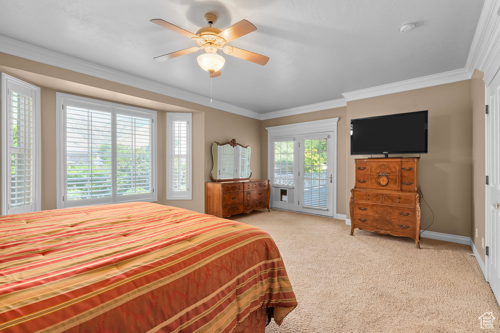 Carpeted bedroom featuring access to exterior, ceiling fan, and ornamental molding