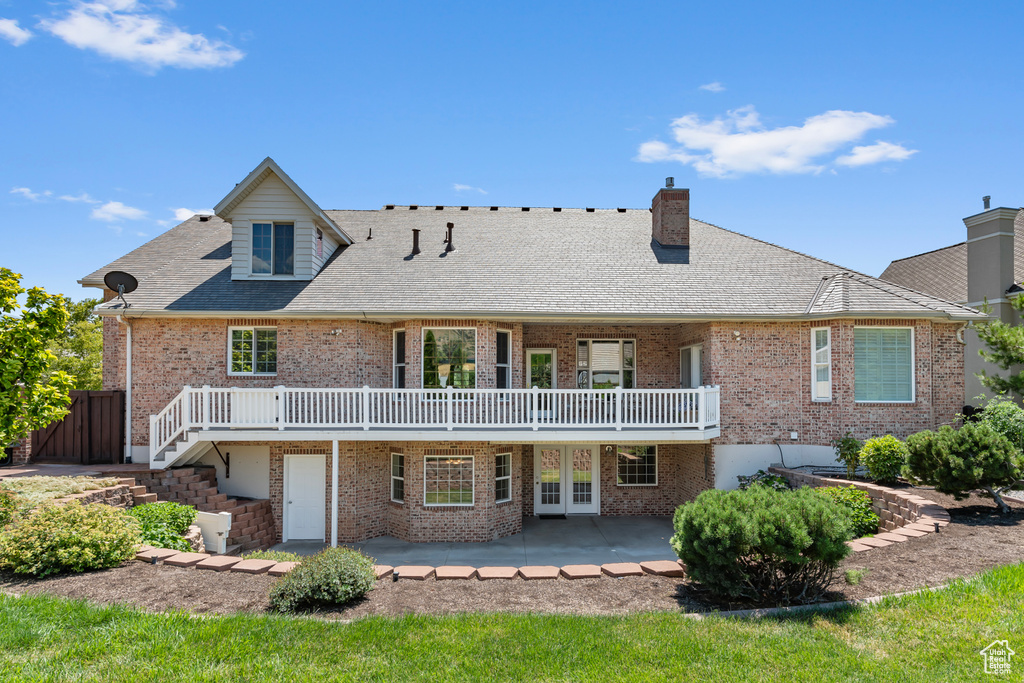 Rear view of house with a patio area and french doors