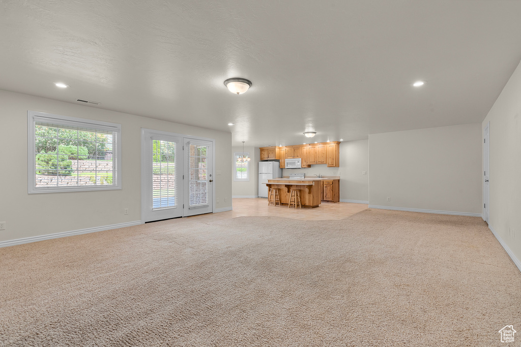 Unfurnished living room featuring light colored carpet