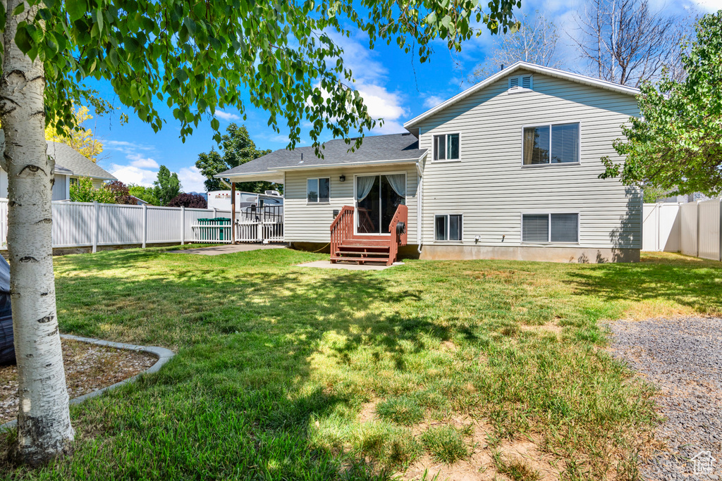 Back of house featuring a yard