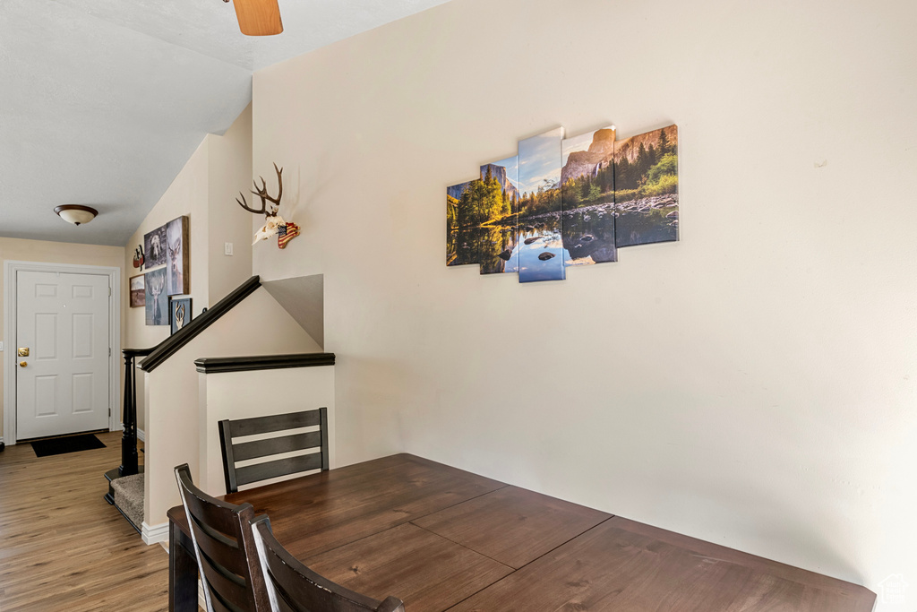 Dining room with hardwood / wood-style flooring and ceiling fan