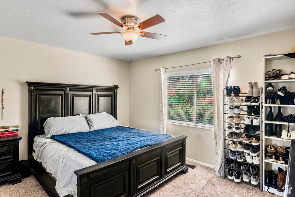 Bedroom with light carpet and ceiling fan