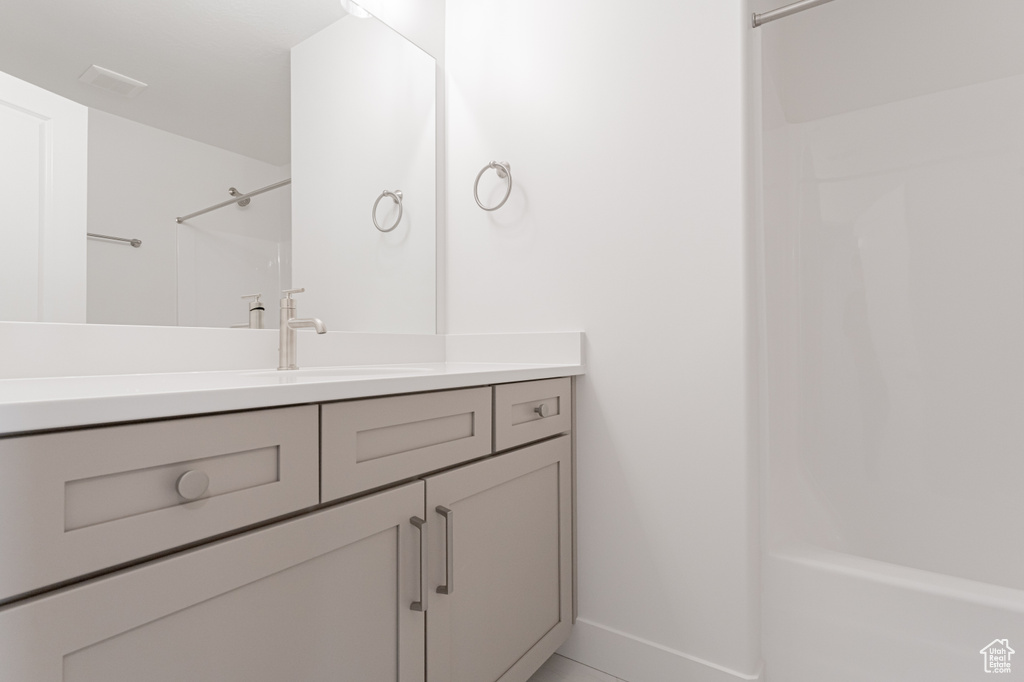 Bathroom with vanity and tub / shower combination