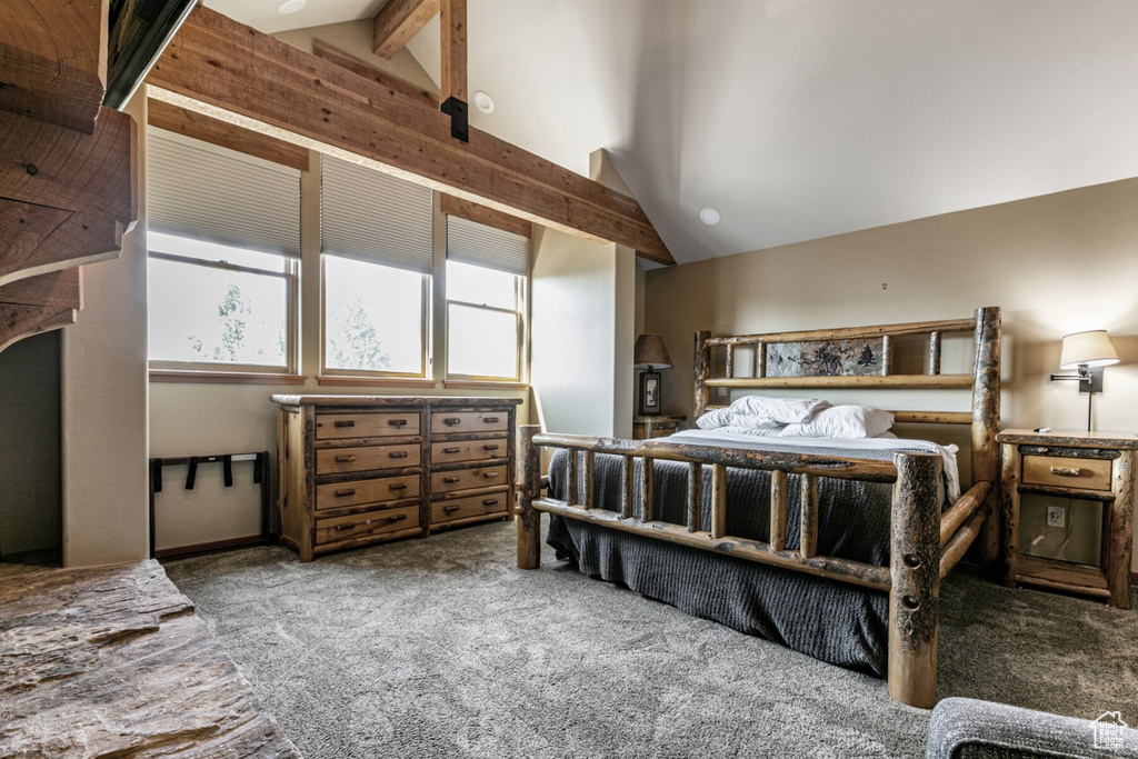 Carpeted bedroom featuring high vaulted ceiling