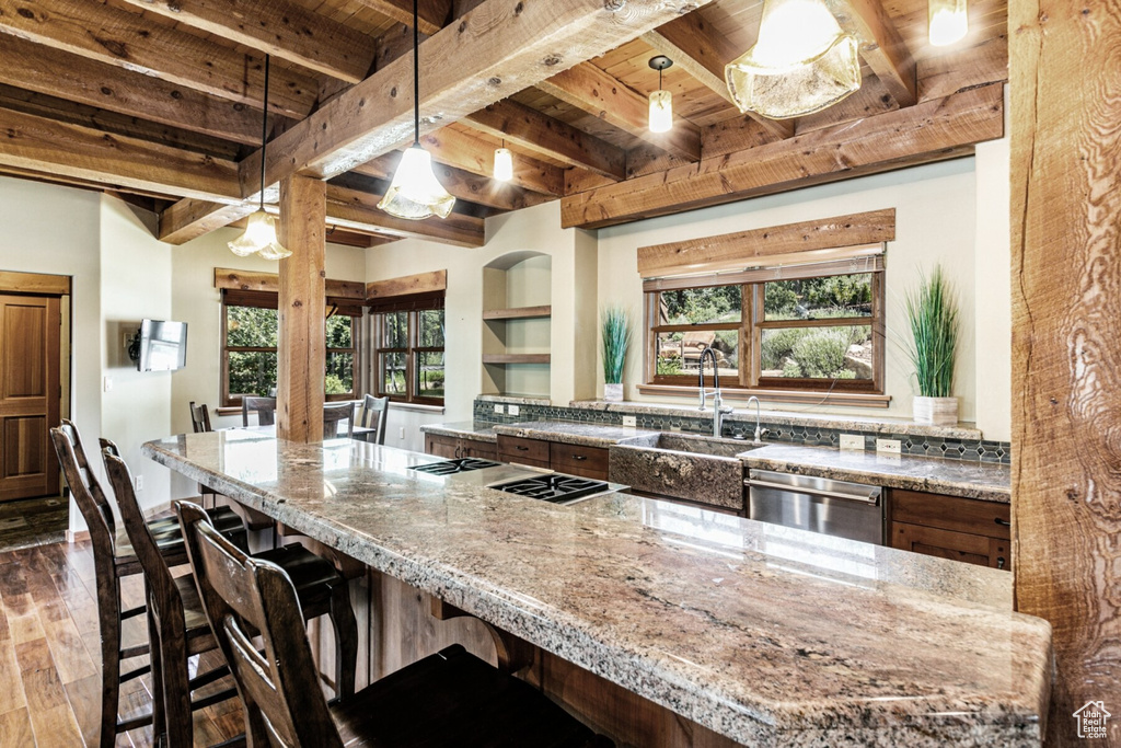 Kitchen featuring wood-type flooring, dishwasher, wooden ceiling, and a healthy amount of sunlight