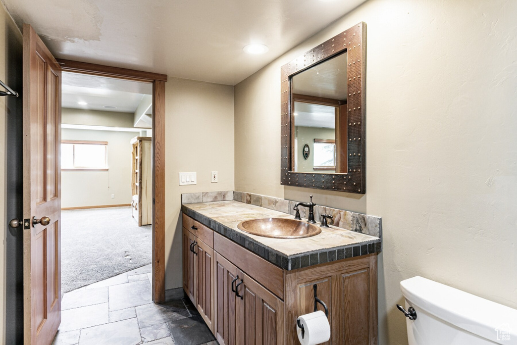 Bathroom with tile patterned floors, vanity, and toilet