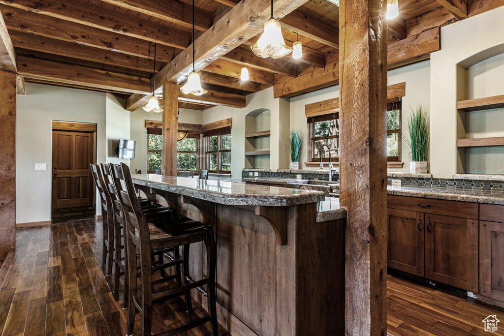 Kitchen featuring wooden ceiling, decorative light fixtures, and beam ceiling