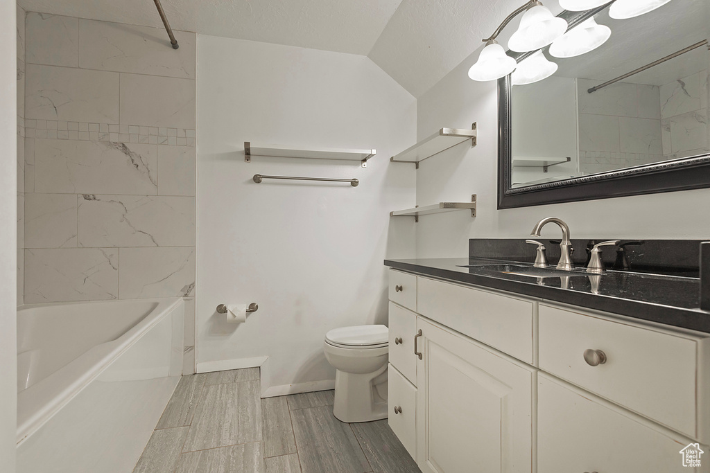 Full bathroom with vanity, toilet, and tiled shower / bath