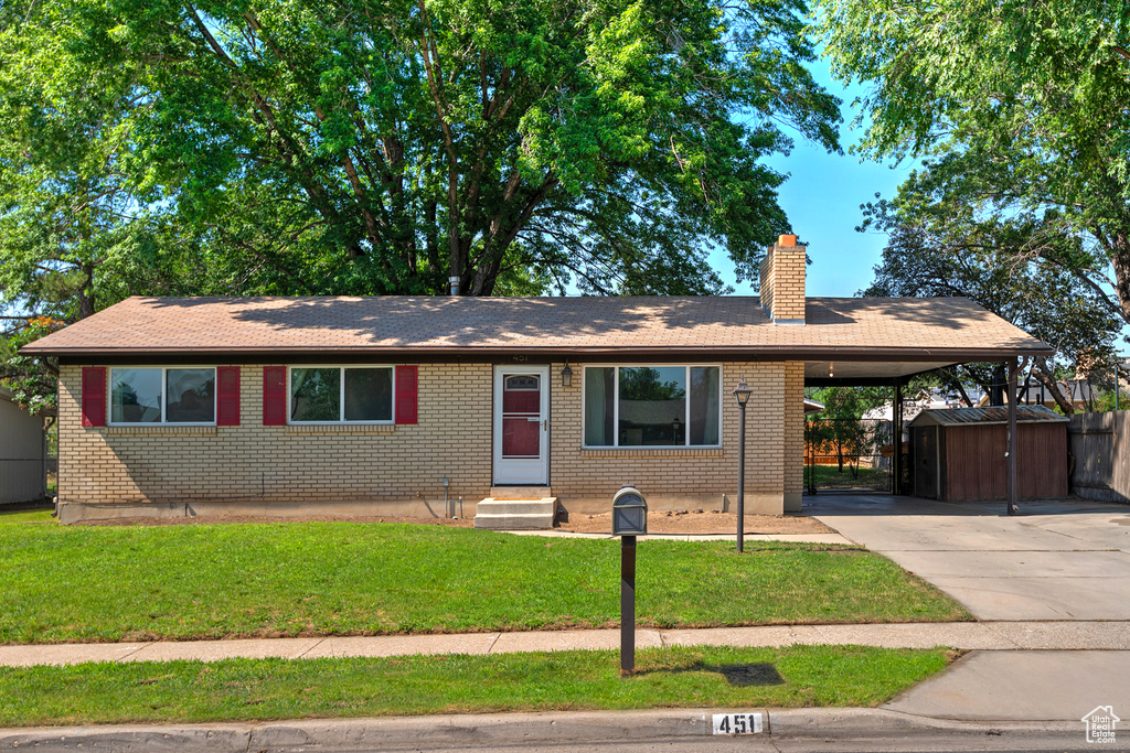 Single story home with a carport and a front yard