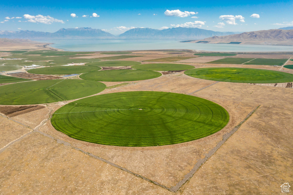 Birds eye view of property with a water and mountain view