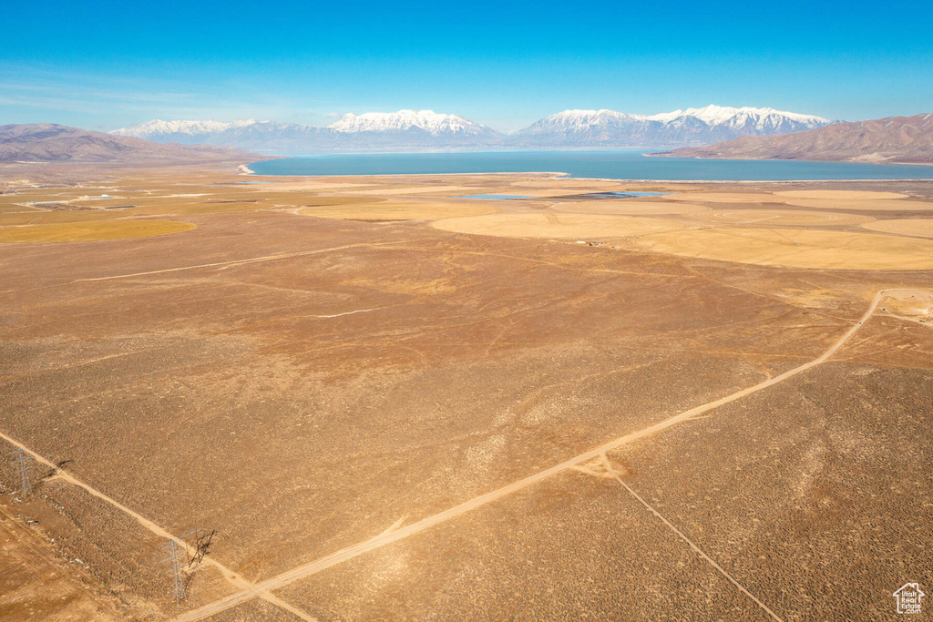Birds eye view of property featuring a water and mountain view