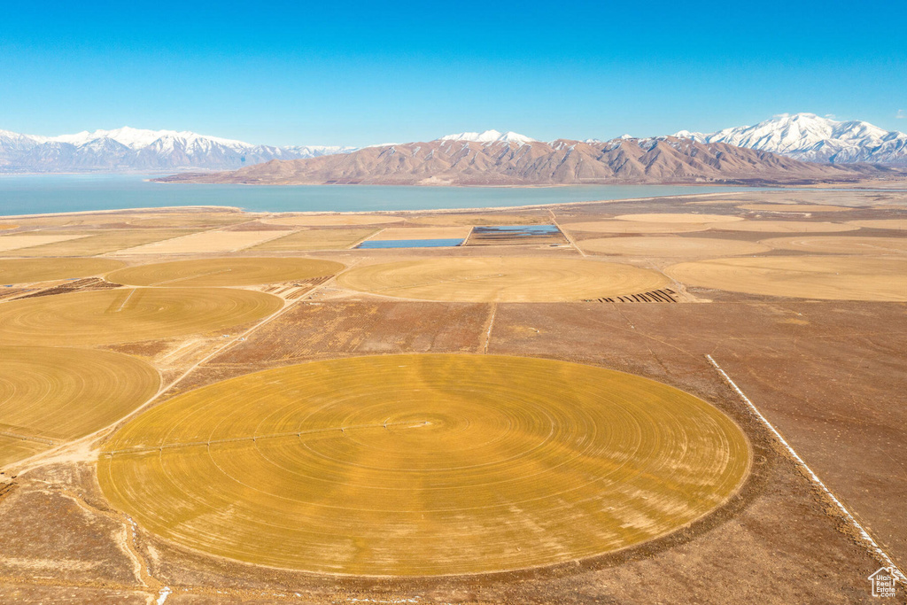 Birds eye view of property with a water and mountain view