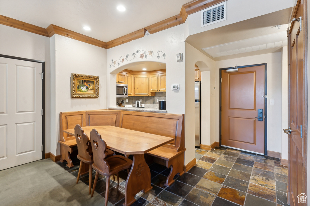 Dining area with dark tile patterned flooring