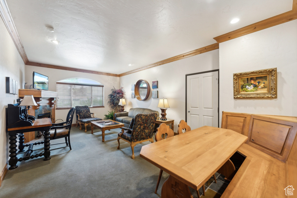 Dining area with crown molding and carpet