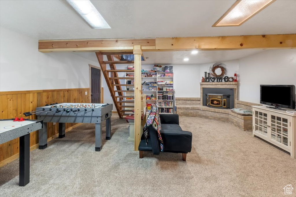 Rec room featuring carpet floors and beamed ceiling