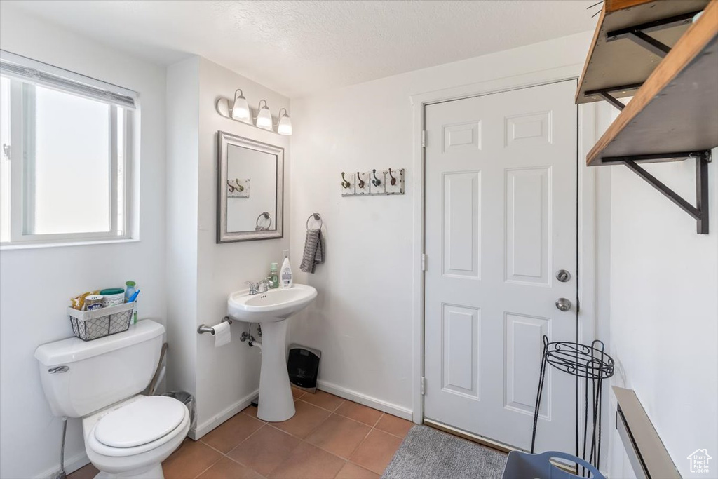 Bathroom with tile patterned floors and toilet