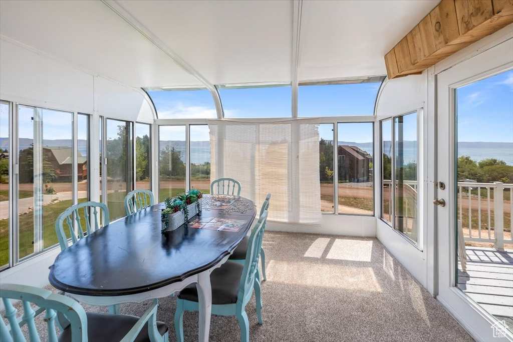 Sunroom featuring a water view