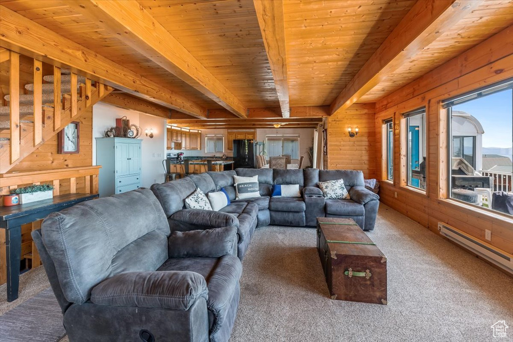 Living room with beamed ceiling, carpet, and wooden ceiling