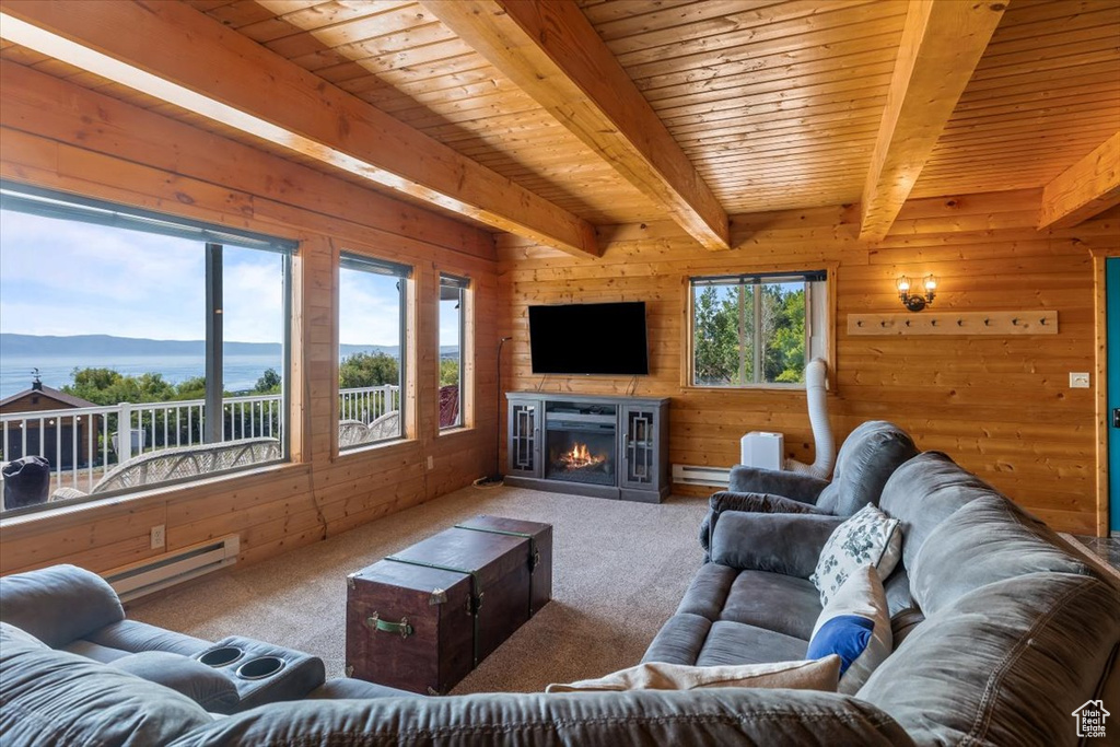 Carpeted living room with beamed ceiling, a water view, wood ceiling, and baseboard heating