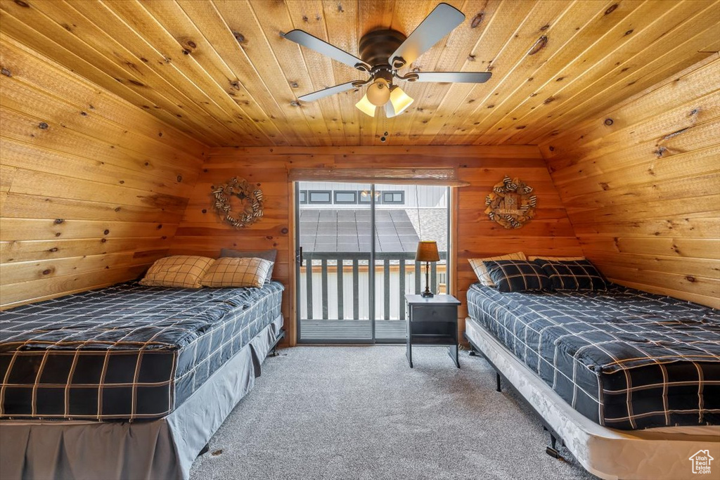 Carpeted bedroom with ceiling fan and wooden ceiling