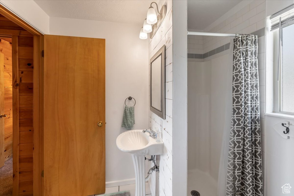 Bathroom with curtained shower