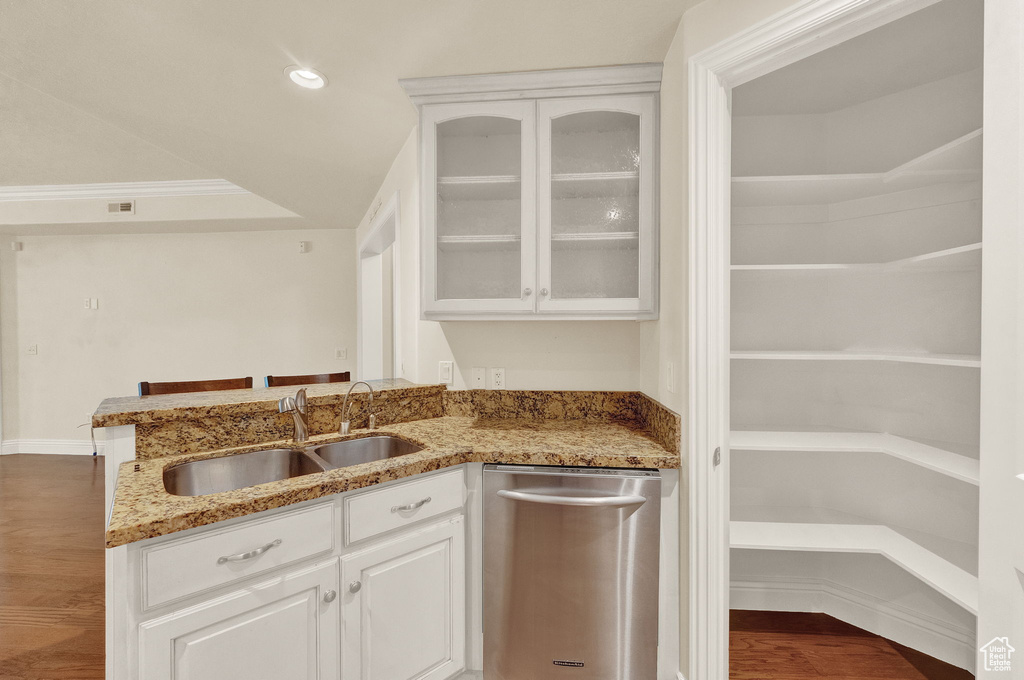 Kitchen featuring crown molding, white cabinets, stainless steel dishwasher, hardwood / wood-style flooring, and sink