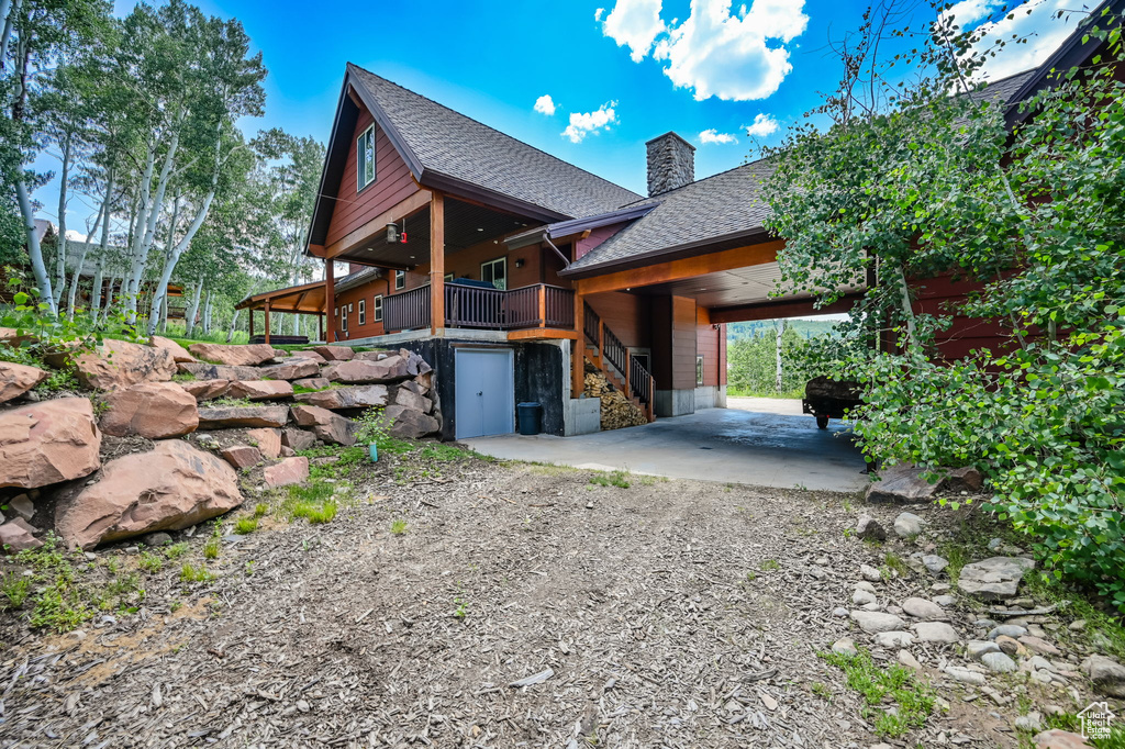 View of side of property with a carport