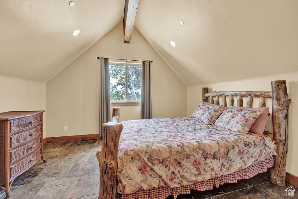 Bedroom with tile patterned floors and vaulted ceiling