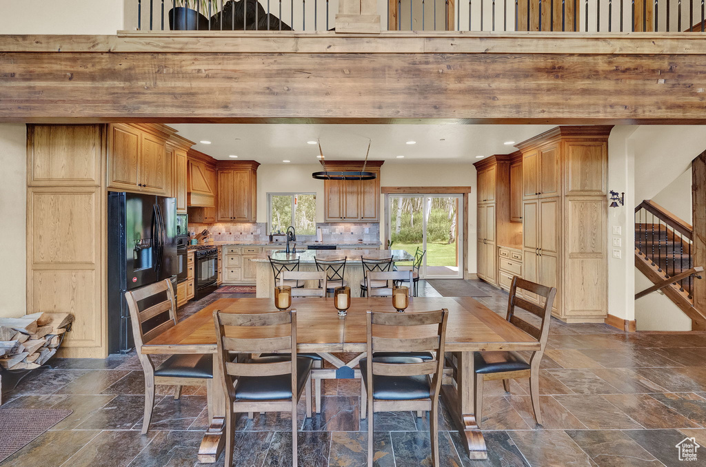 Tiled dining room with a high ceiling