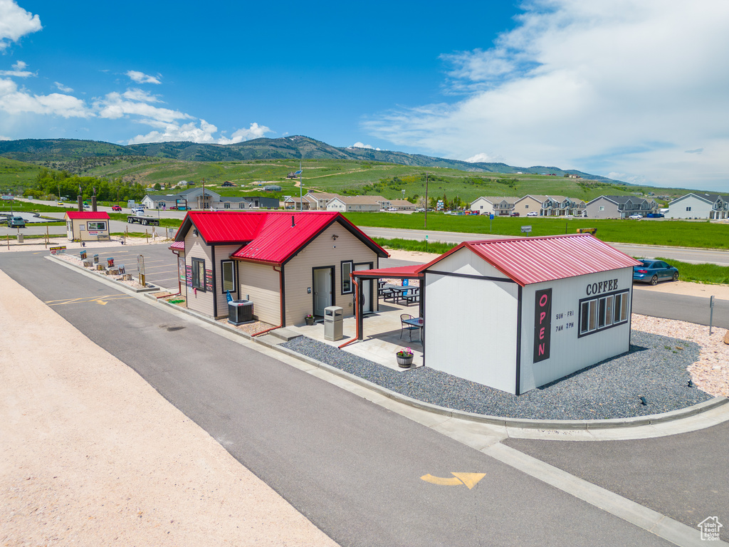 View of front of home featuring a mountain view and cooling unit