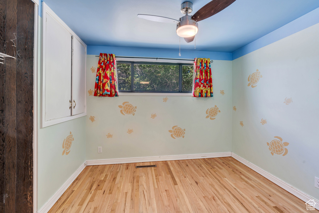 Spare room featuring ceiling fan and light wood-type flooring