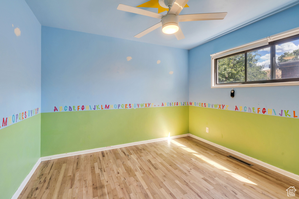 Unfurnished room featuring ceiling fan and light hardwood / wood-style flooring