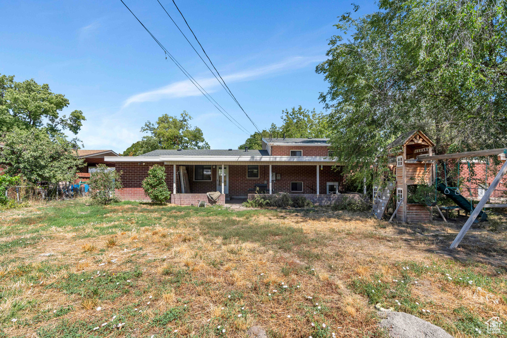 Back of property with a playground