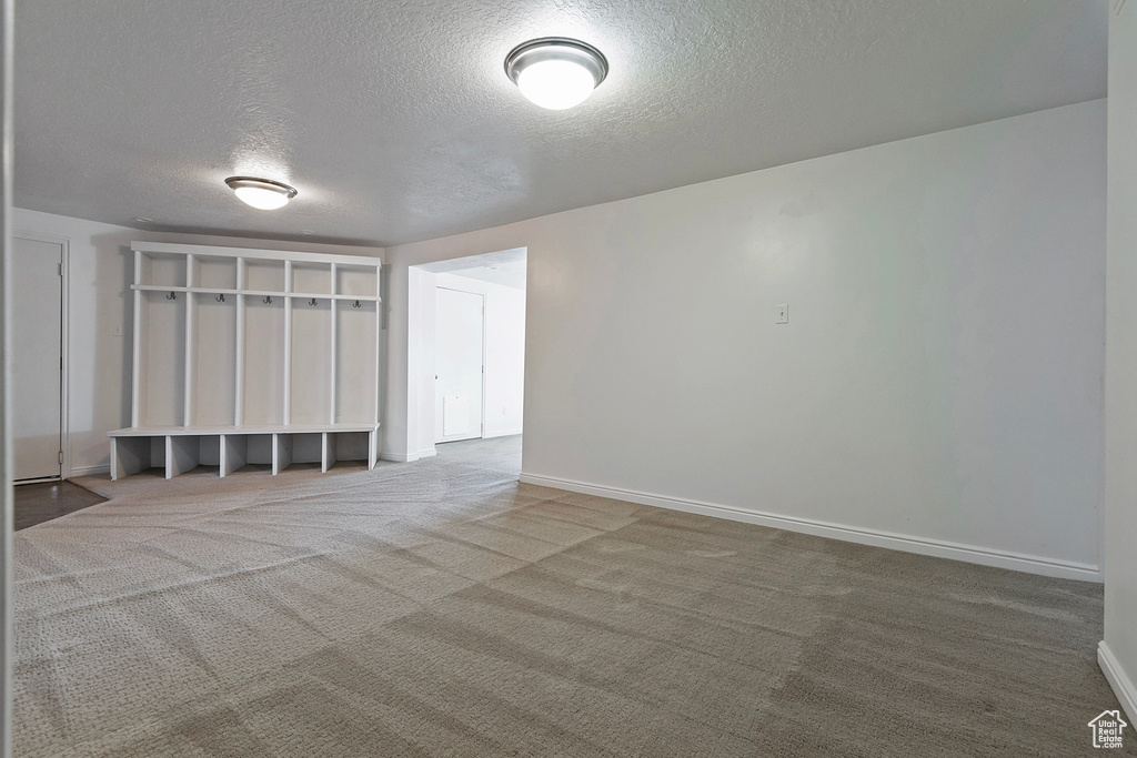 Spare room with carpet and a textured ceiling