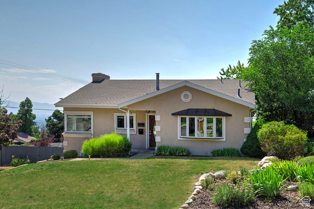 Bungalow-style home with a front yard