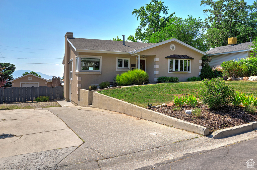 Ranch-style home featuring a front yard