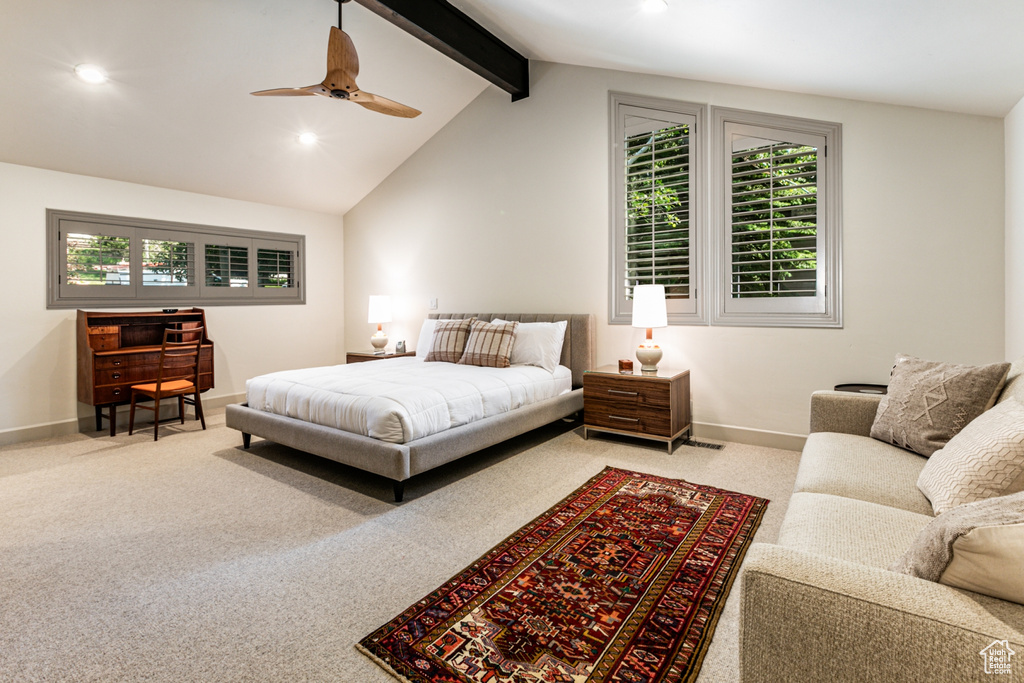 Bedroom featuring vaulted ceiling with beams, carpet, and multiple windows