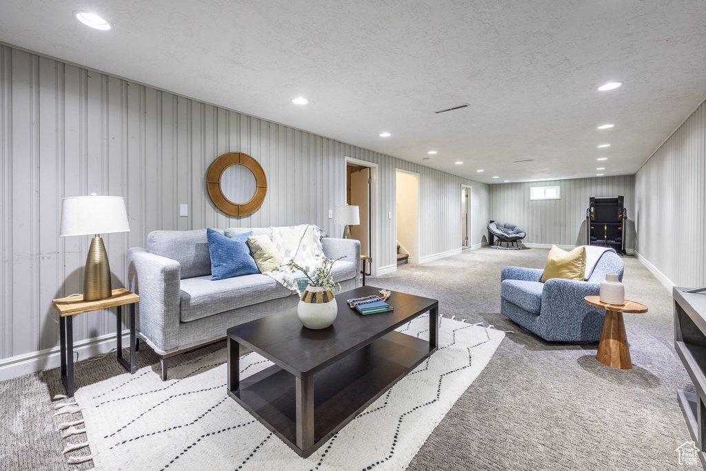 Carpeted living room with a textured ceiling