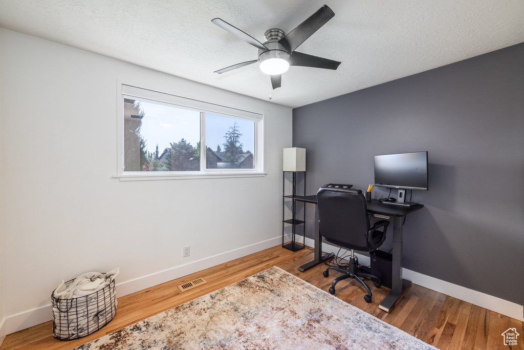 Office featuring ceiling fan and wood-type flooring