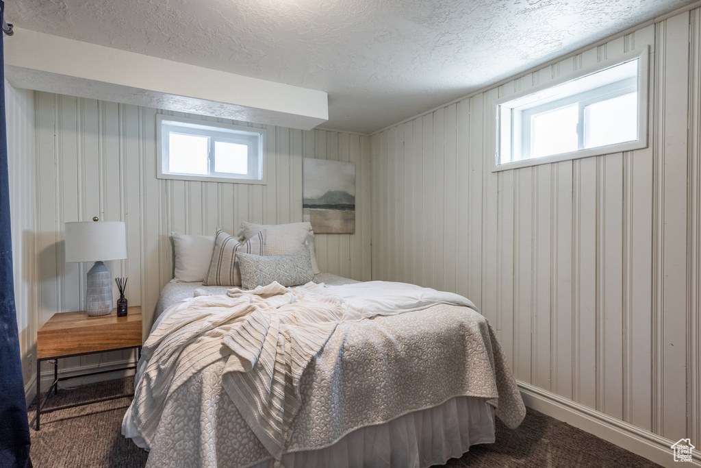 Carpeted bedroom with a textured ceiling