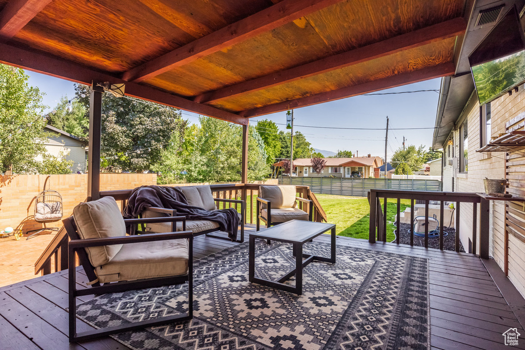 Deck featuring an outdoor living space and a lawn