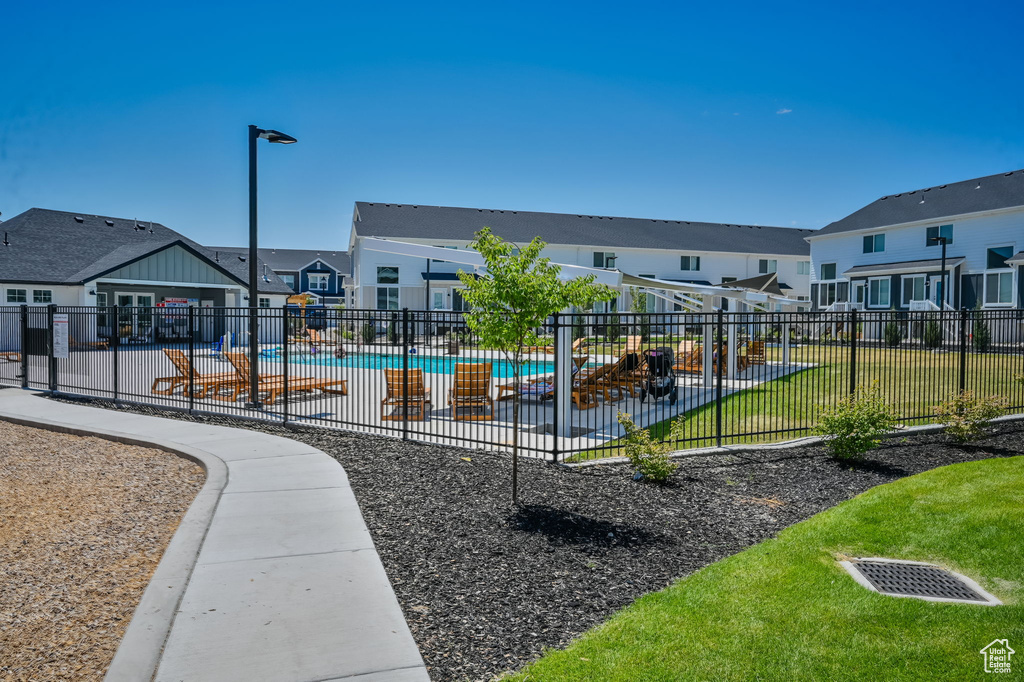 Surrounding community featuring a patio area, a swimming pool, and a yard